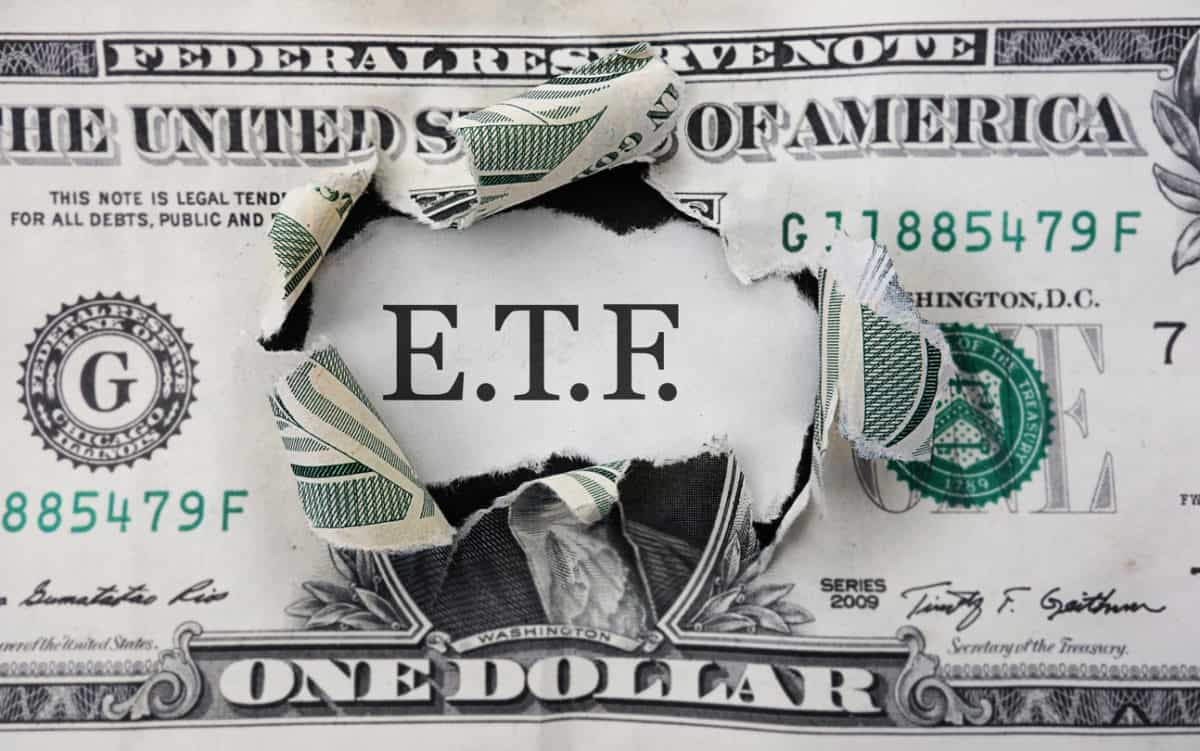 Torn dollar with ETF message