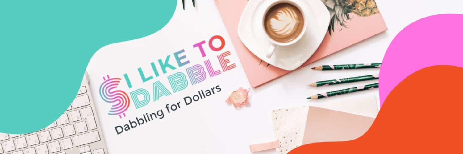 A creative and colorful workstation featuring the slogan 'i like to dabble - dabbling for dollars', with a stylish keyboard, a cup of latte art, notepads, pencils, and decorative elements, encapsulating the essence of a fun and quirky side hustle or hobbyist workspace.