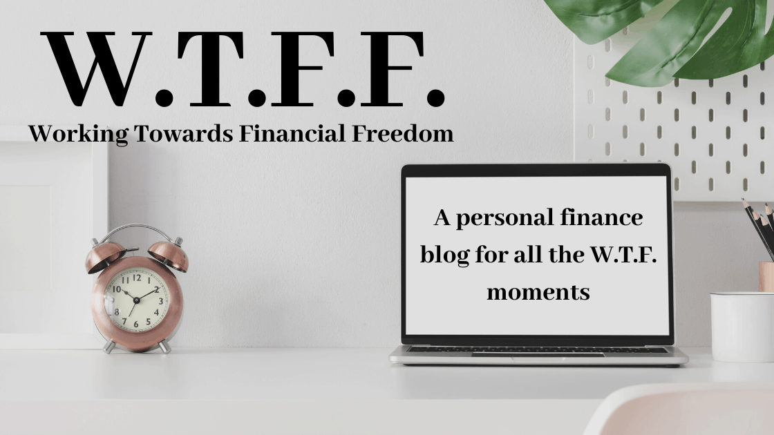 A minimalist home office setup featuring a motivational acronym for financial independence, highlighting a blog that addresses personal finance challenges.