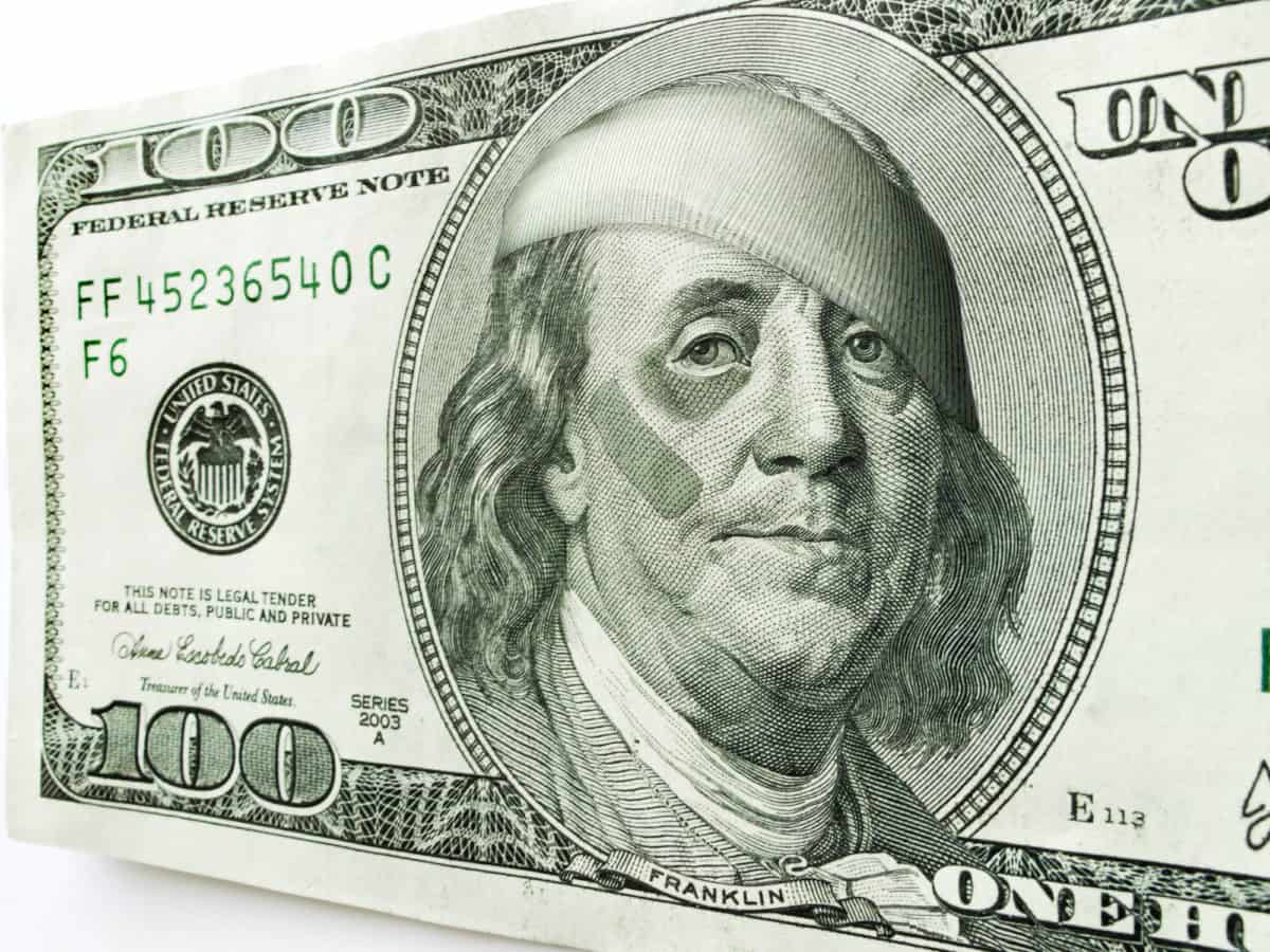 This photo illustration of Ben Franklin with a black eye and bandages on a one hundred dollar bill might illustrate a tough economy, inflation, unemployment, economic recession, or budget cuts etc.