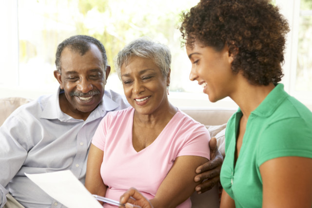 Senior Couple Talking To a Chartered Retirement Planning Counselor At Home