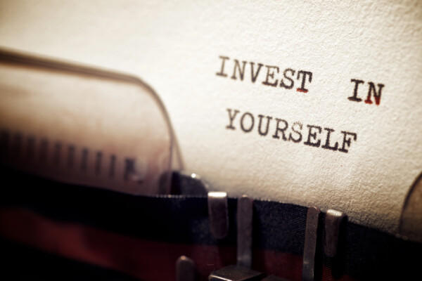 Invest in yourself phrase written with a typewriter.