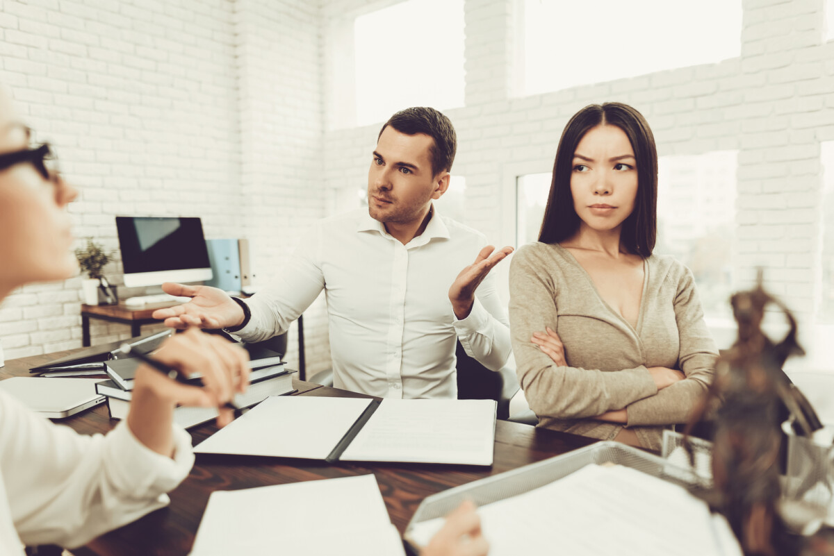 Upset Husband and Angry Wife in Office with divorce financial planner.