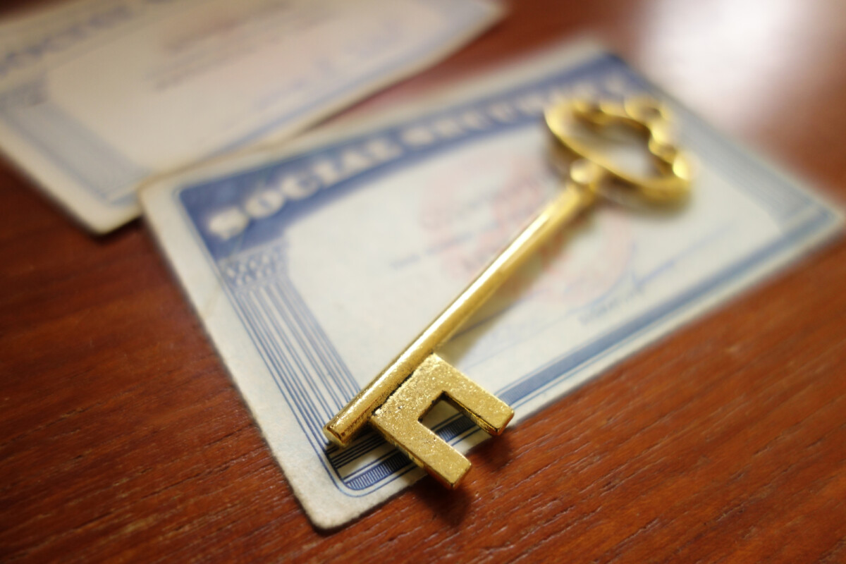 Closeup of a key and Social Security cards.