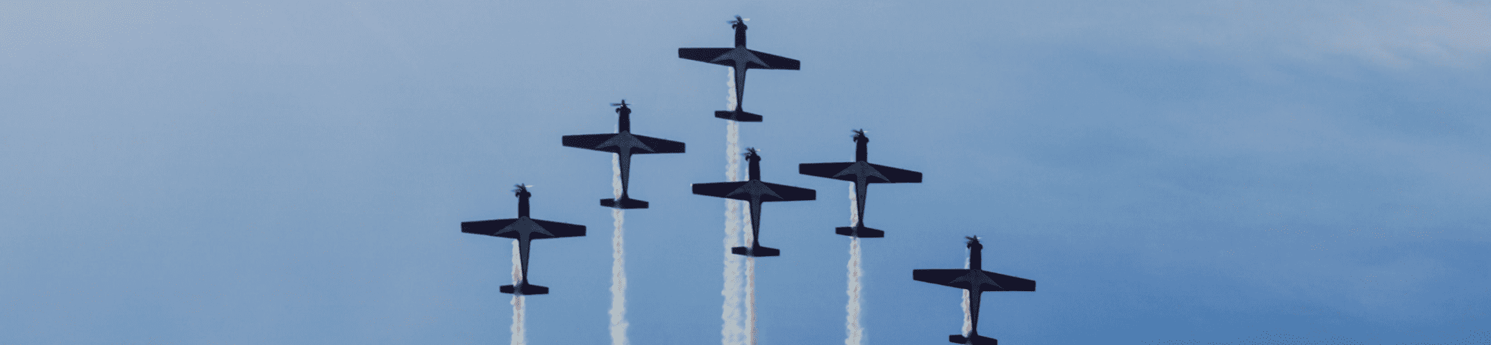 Synchronized ascent: military aircraft in tight formation, piercing the sky with precision and grace.